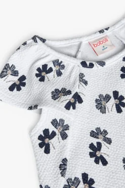 Abito in maglia per bambina con design floreale in bianco e nero.