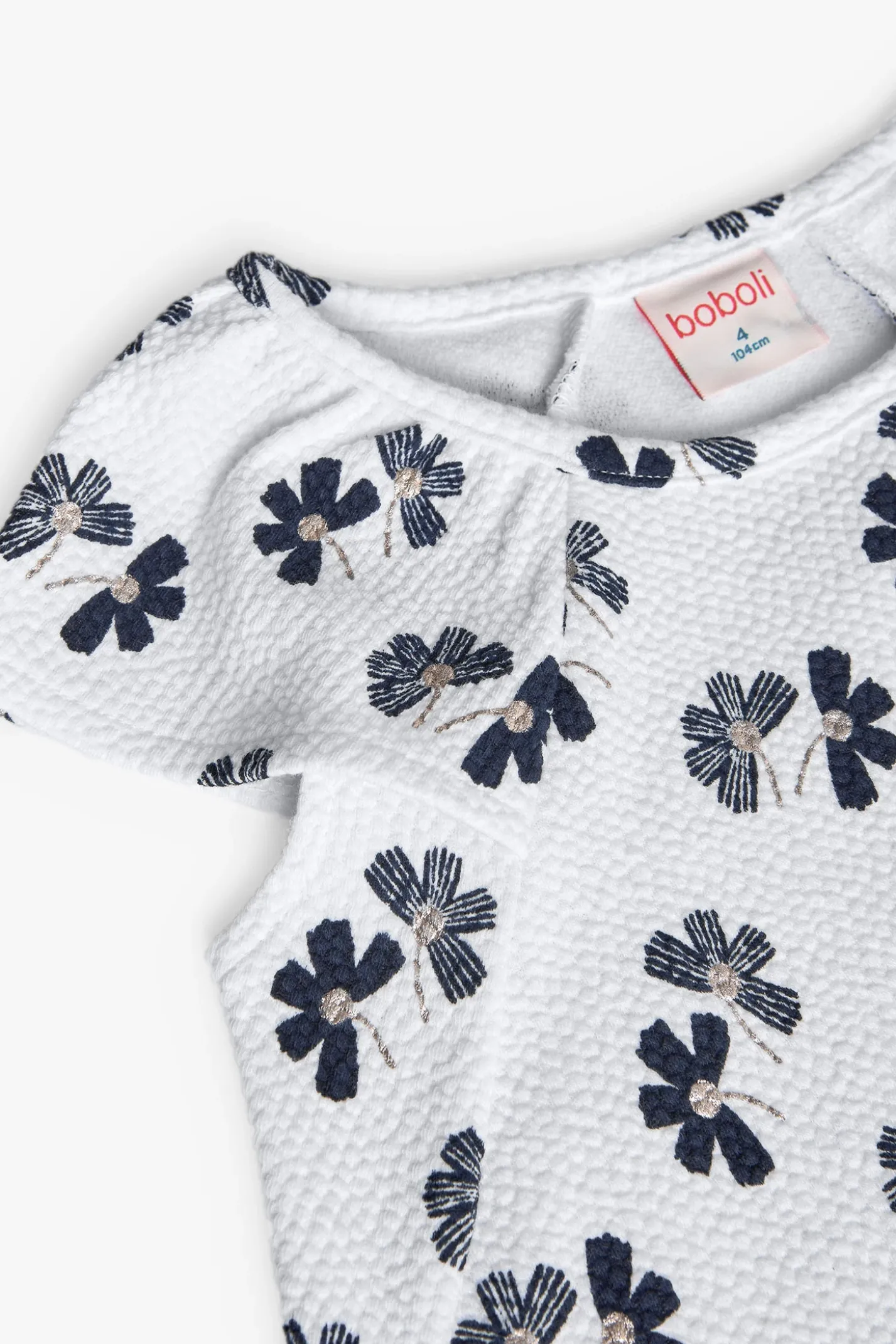 Abito in maglia per bambina con design floreale in bianco e nero.