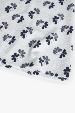 Abito in maglia per bambina con design floreale in bianco e nero.