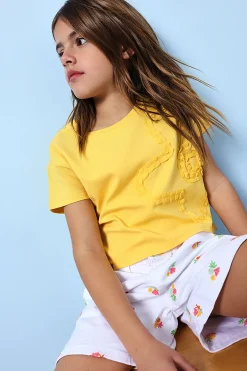 Bermuda in maglia per bambina di colore bianco con motivo floreale.