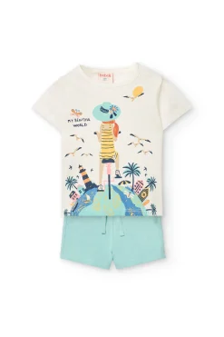 Completo di maglietta e pantaloncini a maglia per neonata di colore bianco.