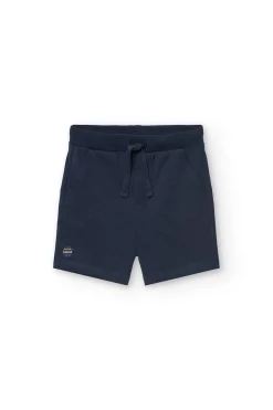 Completo di maglietta e pantaloncini in maglia per bambino in colore bianco.
