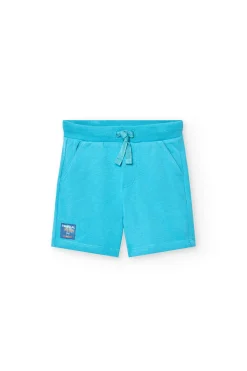 Completo in maglia per neonato di colore bianco con stampa e pantaloncini di colore blu.