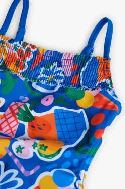 Costume da bagno in poliammide per bambina con stampa di frutta e fiori in colore blu.
