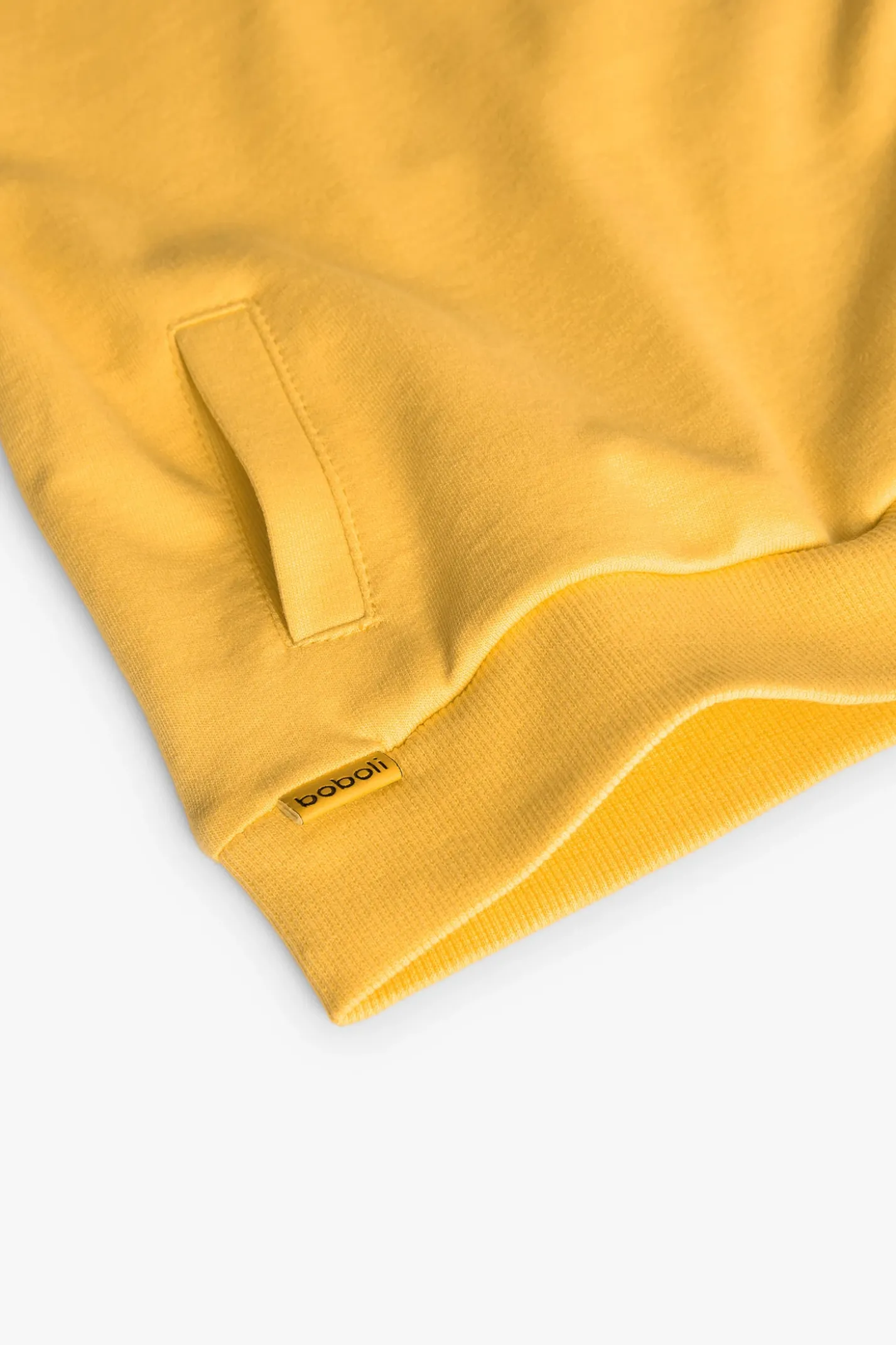 Felpa per neonato di colore giallo.