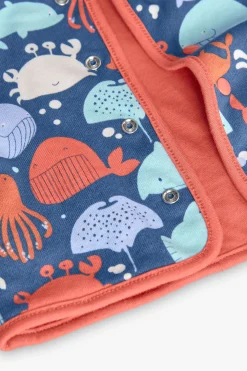 Giacca reversibile a maglia per neonato in colore rosso e con stampa.