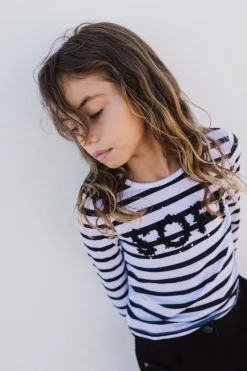 Maglietta a maglia per bambina con design a righe nei colori bianco e nero