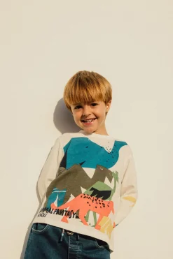 Maglietta a maglia per bambino in colore bianco con motivo di dinosauri