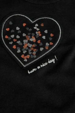Maglietta a maglia per bambina di colore nero con motivo a cuore.