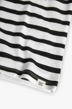 Maglietta a maglia per bambina con design a righe nei colori bianco e nero