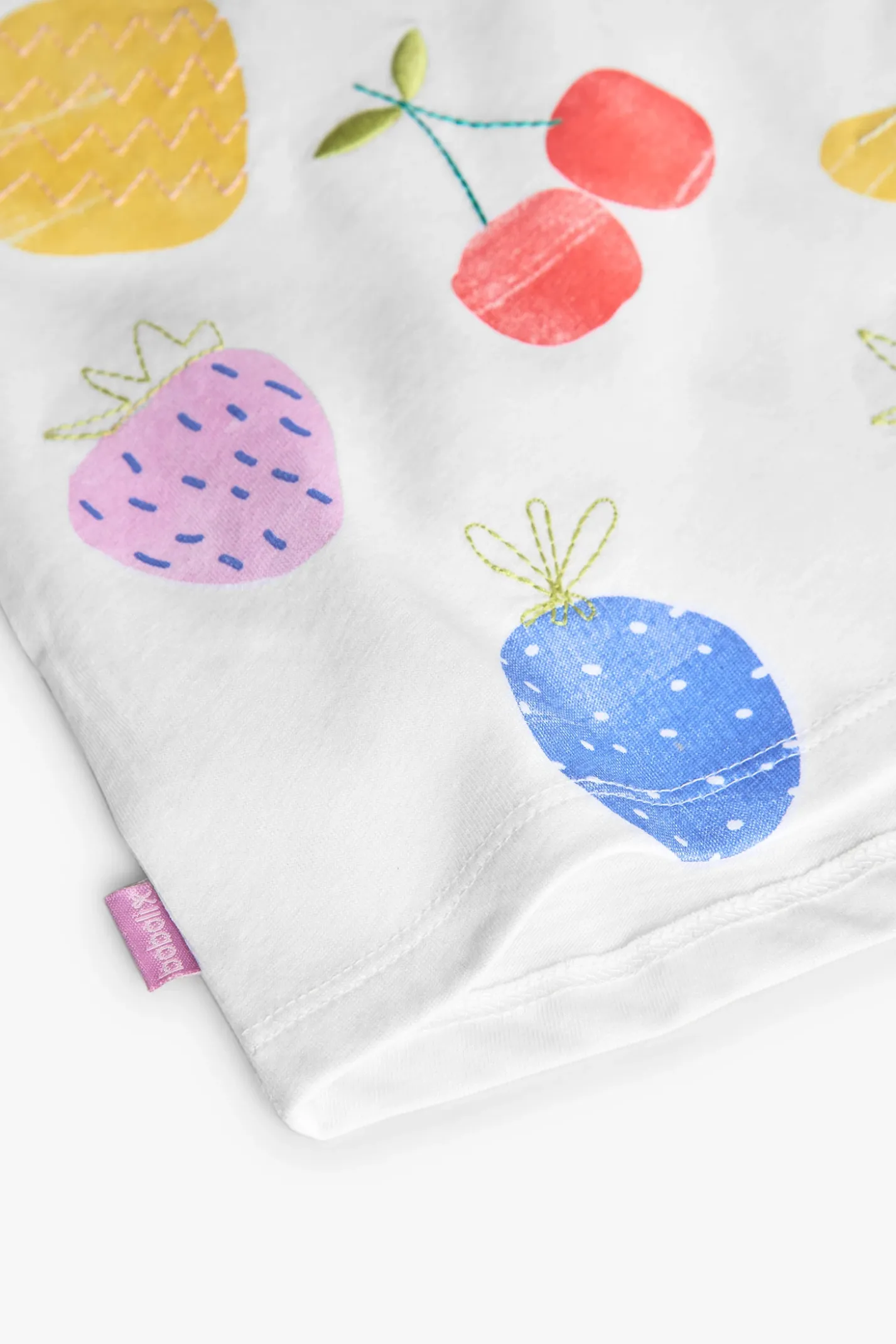 Maglietta a maglia per neonata in colore bianco con stampa di frutti