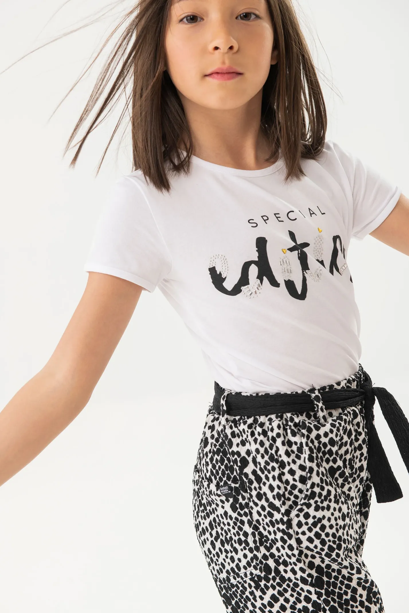 Maglietta di maglia elastica per bambina di colore bianco