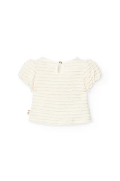 Maglietta di maglia per neonata in colore bianco.