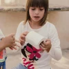 Maglietta in maglia per bambina a maniche lunghe di colore bianco.