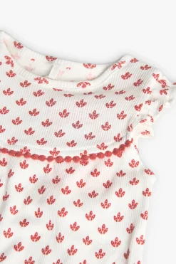 Pagliaccetto in maglia per neonata di colore bianco con motivo di fiori rossi.