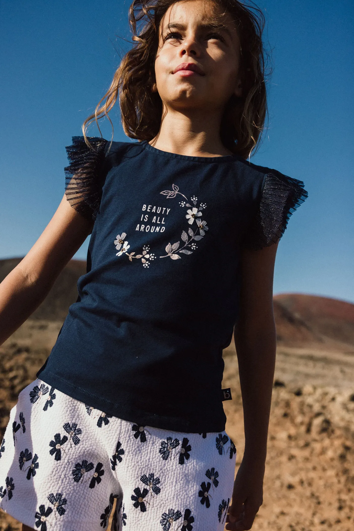 Pantaloncini in maglia per bambina con stampa floreale in bianco e blu
