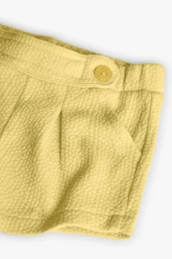 Pantaloncini in maglia per neonata in colore giallo
