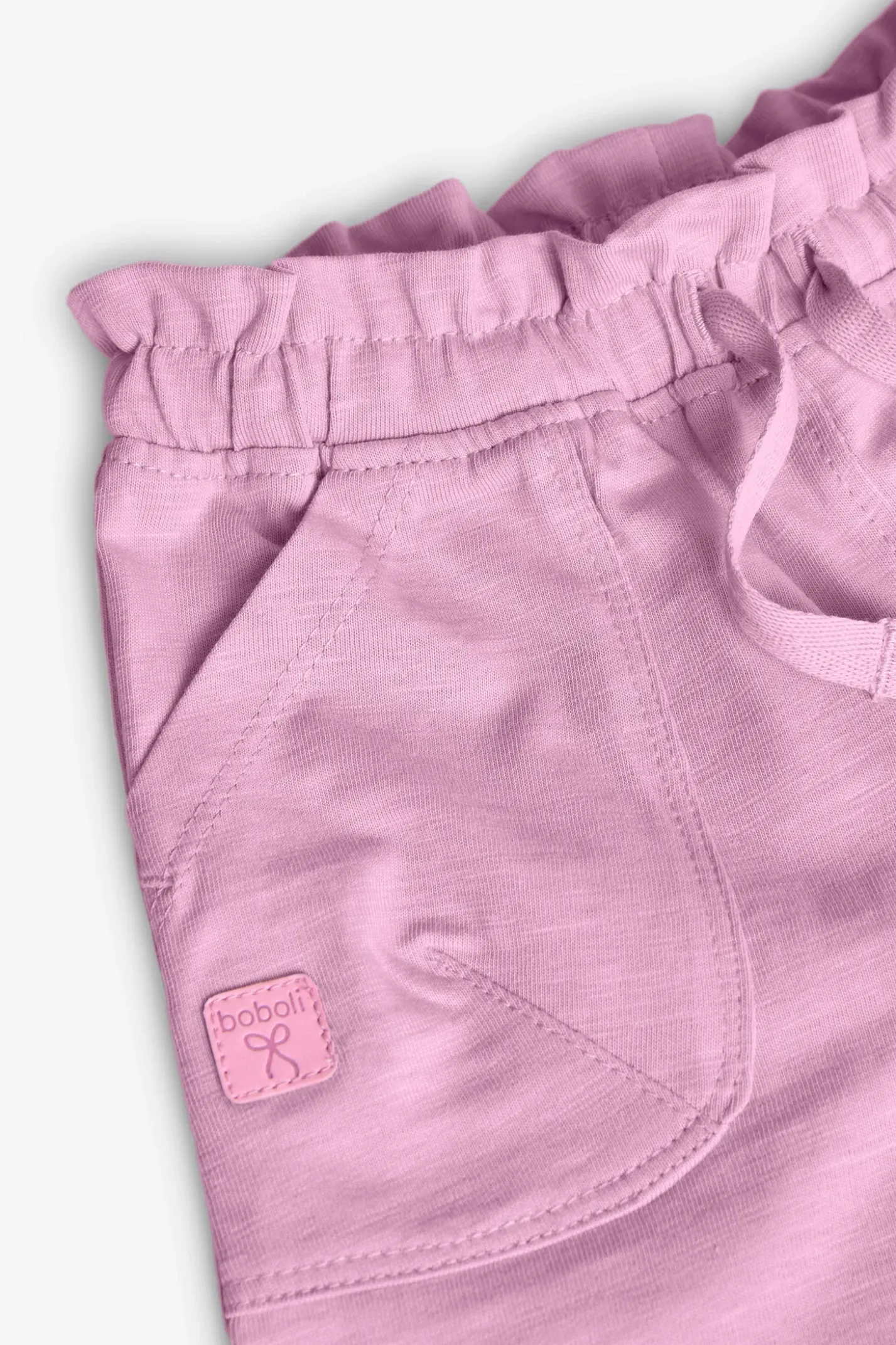 Pantaloncini in maglia per neonata di colore rosa