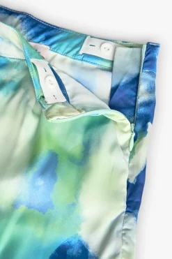 Pantaloni larghi in raso per bambina con stampa nei colori blu e verde