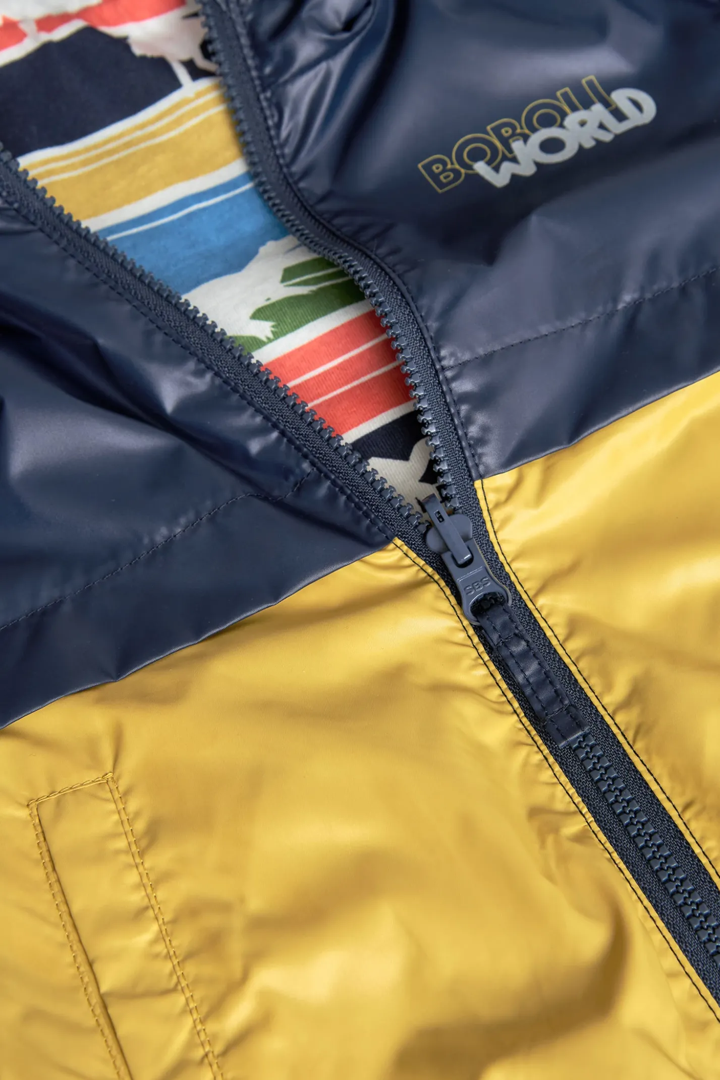 Parka reversibile per neonato in colore senape e nero con stampa