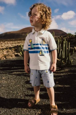 Polo lavorato a maglia per neonato di colore bianco con stampa nautica.