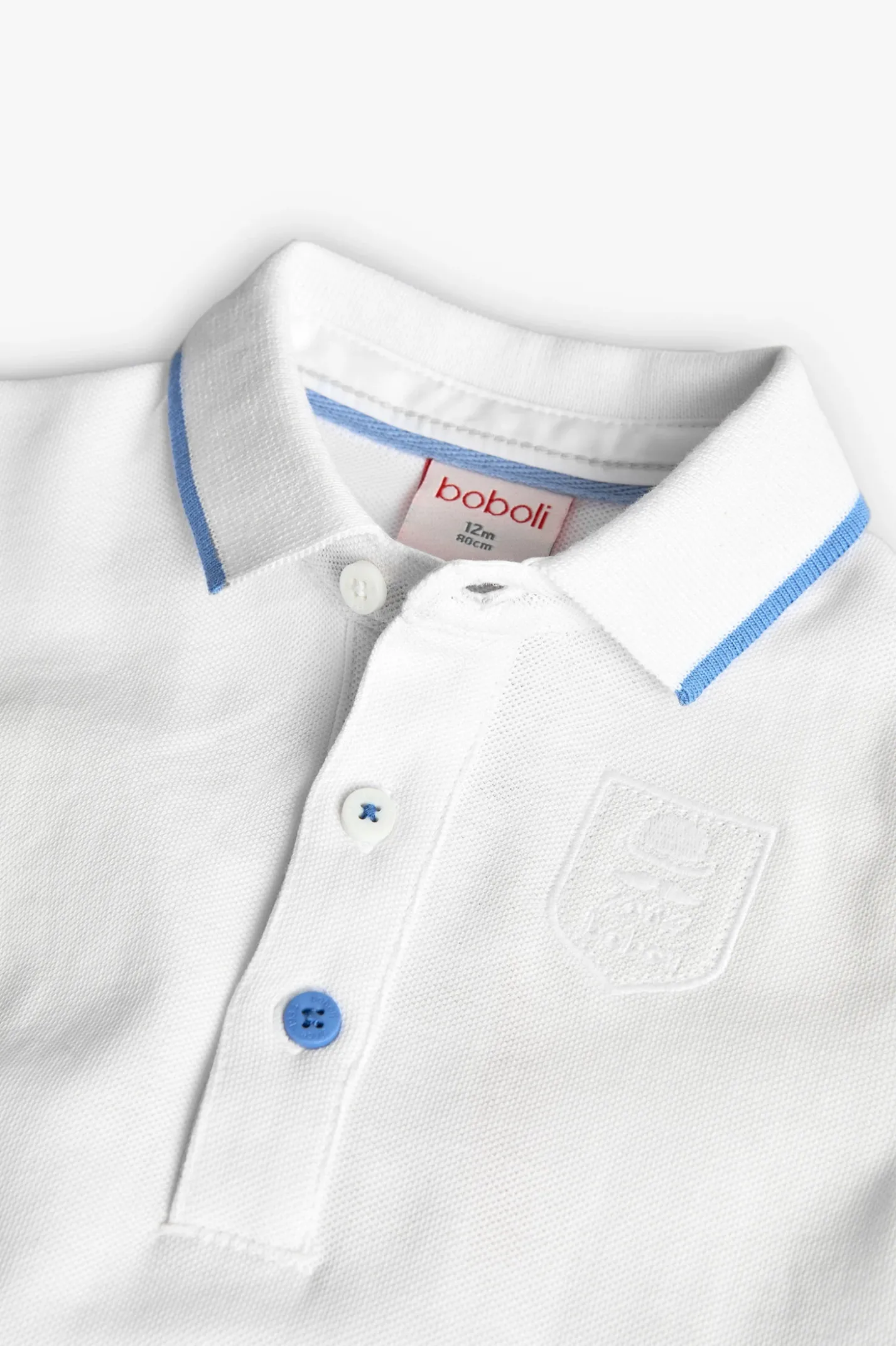 Polo piqué per bambino in colore bianco.