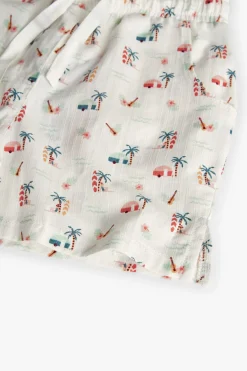 Short in batista per bambina con stampa tropicale in colore chiaro.