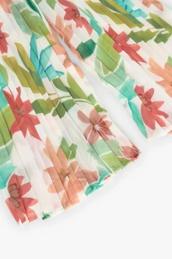 Tuta di chiffon plissettato per bambina con motivo floreale nei colori rosa e verde.