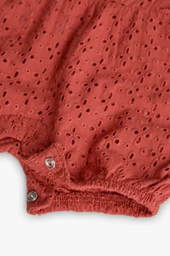 Tutina a maglia per bambina in colore arancione ricamata