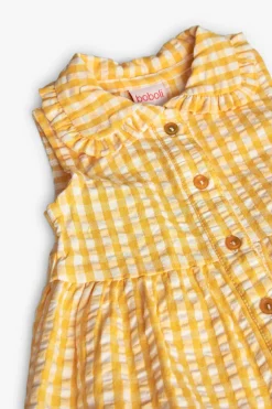 Vestito di popeline per neonata con stampa a quadri di colore giallo.