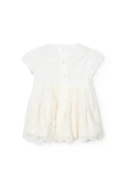 Vestito di tulle per bambina ricamato in colore bianco.